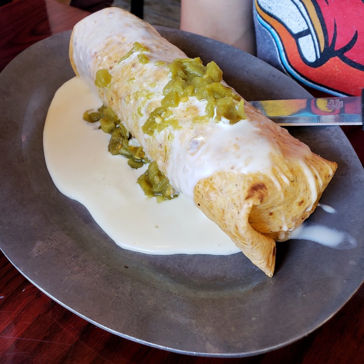 Breakfast Burrito at BisQit in Pawley's Island SC (scrambled eggs, home fries, jalapeno bacon, and melted cheese, smothered in house queso, topped with roasted green chiles)